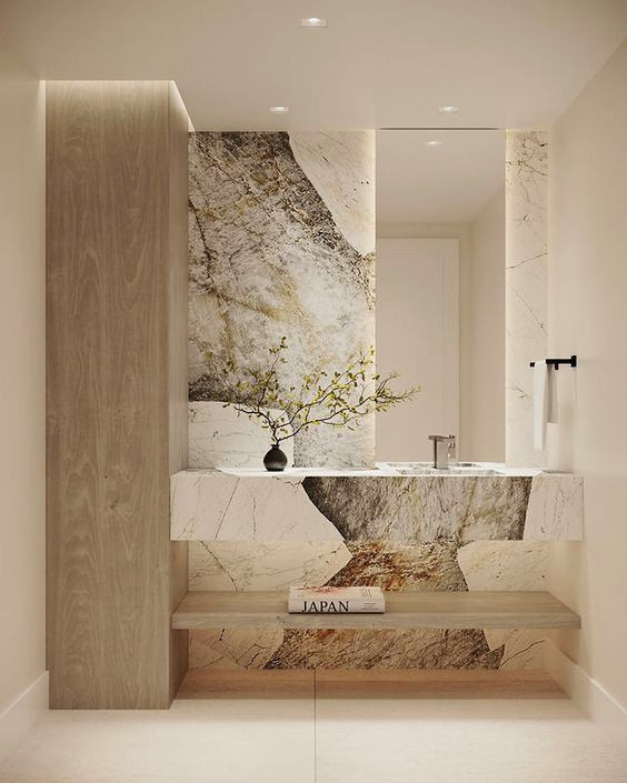 Sculptural powder room with bookmatched stone vanity
